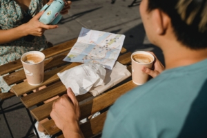 people talking over coffee outside at table